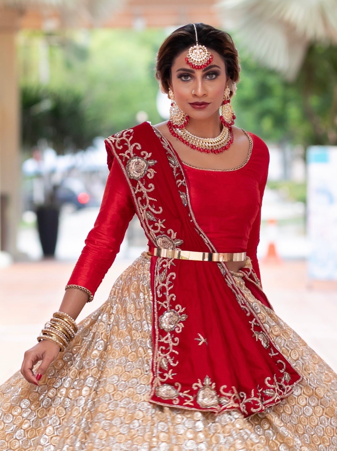 Red Arunima Bridal lehenga with raw silk blouse belt and a tulle dupatta